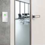 Open white door with metallic handle. The door to the bedroom